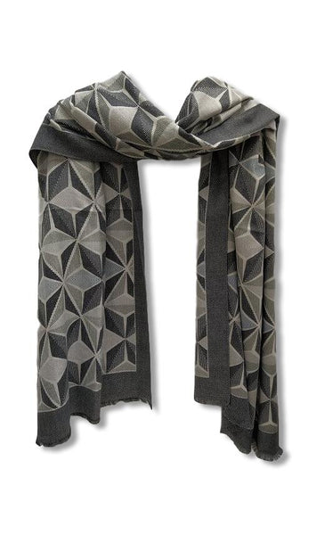 A pashmina weight scarf with a geometric design in shades of grey