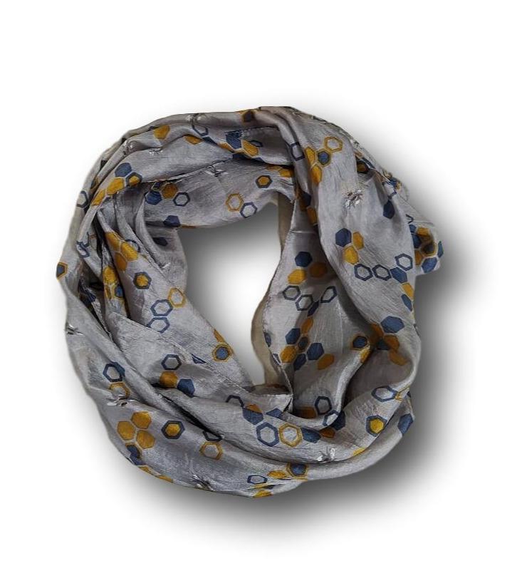 A grey silk scarf with a hexagon design